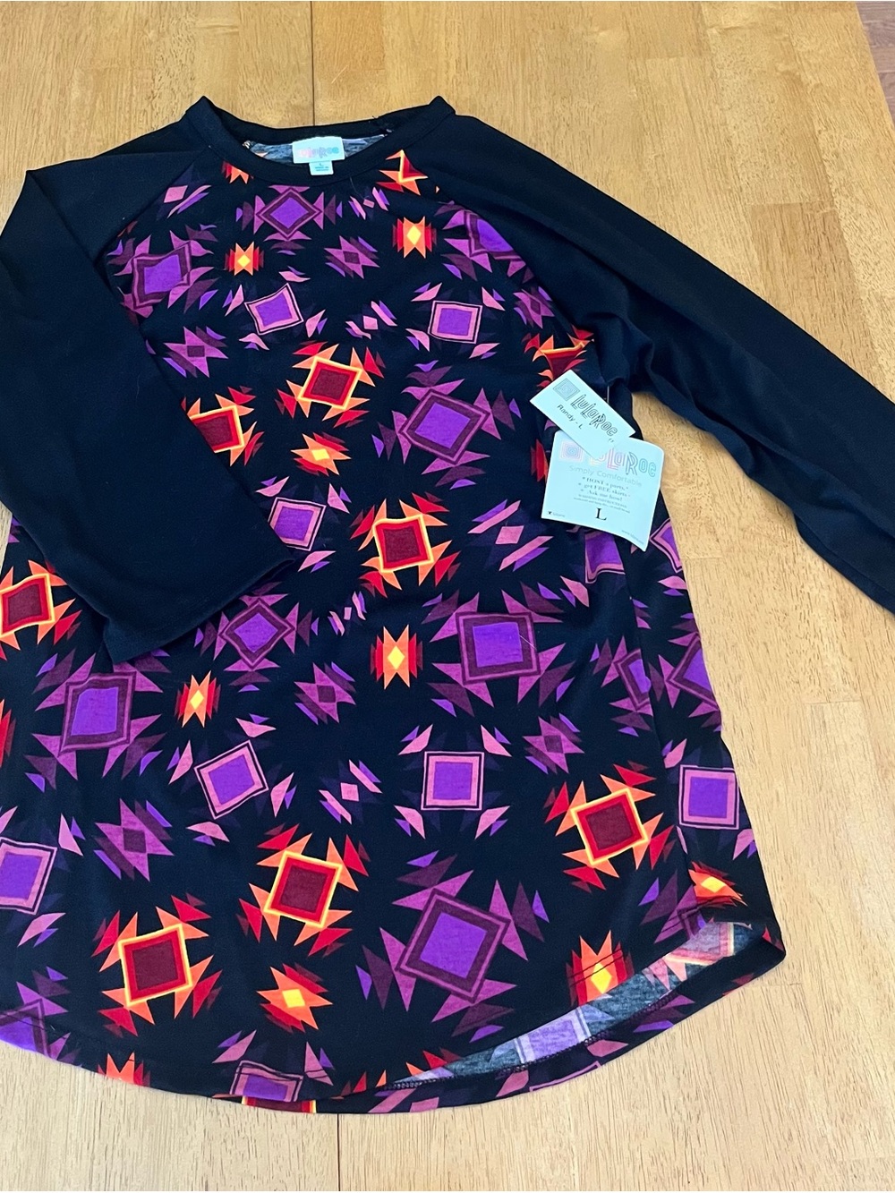 LuLaRoe Randy Black Top with Purple & Neon Orange Geometric Print
